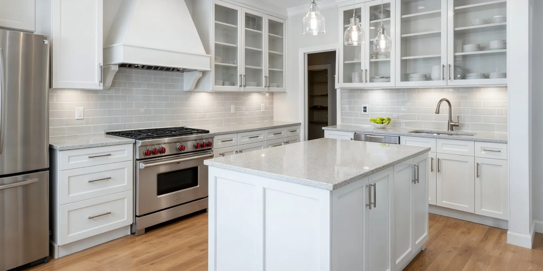 Completed kitchen remodeling project in Los Angeles with white cabinets, island, and modern appliances