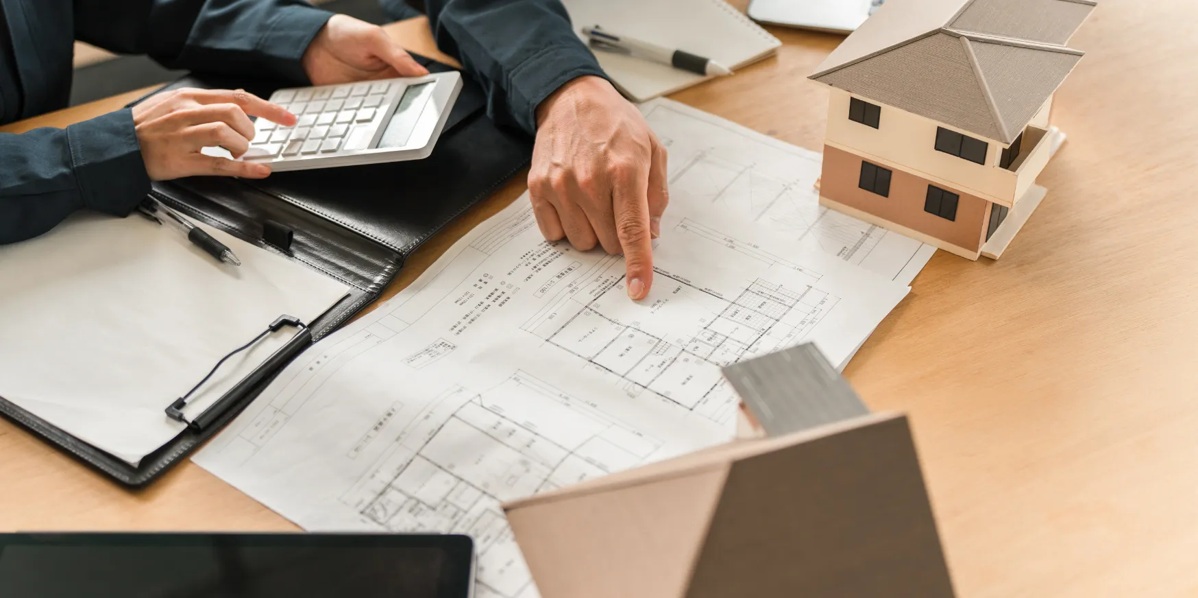 Custom home builders in Los Angeles reviewing architectural plans and designing a luxury residential home