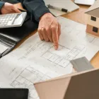 Custom home builders in Los Angeles reviewing architectural blueprints for a new luxury home project